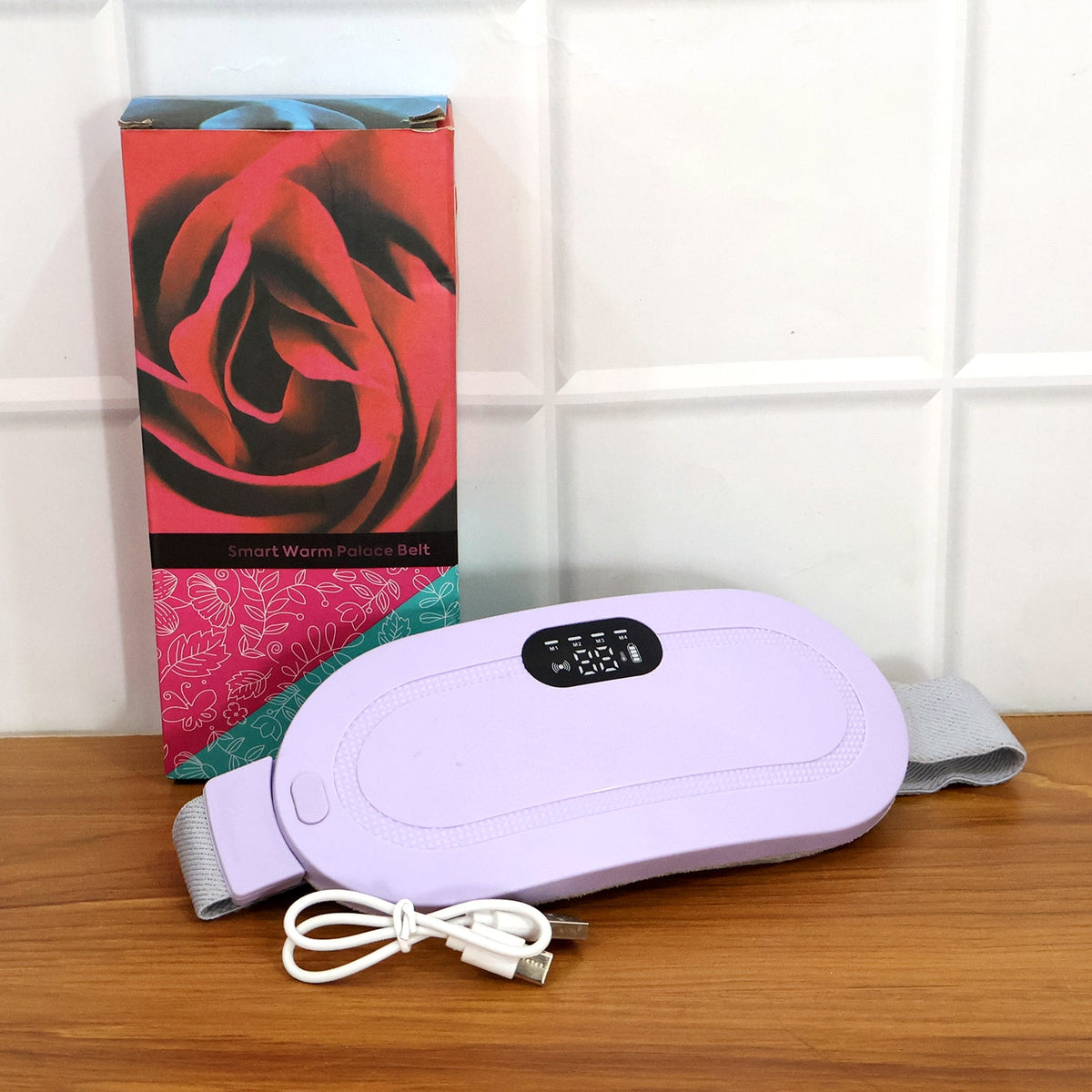 Woman comfortably using the portable heating pad for pain relief at home for relaxation.