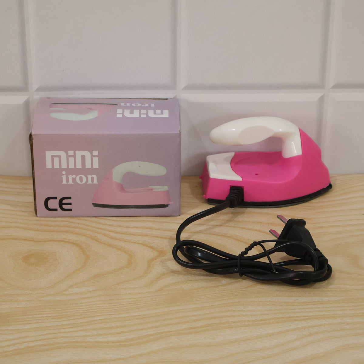 Lifestyle image of pink portable mini electric iron