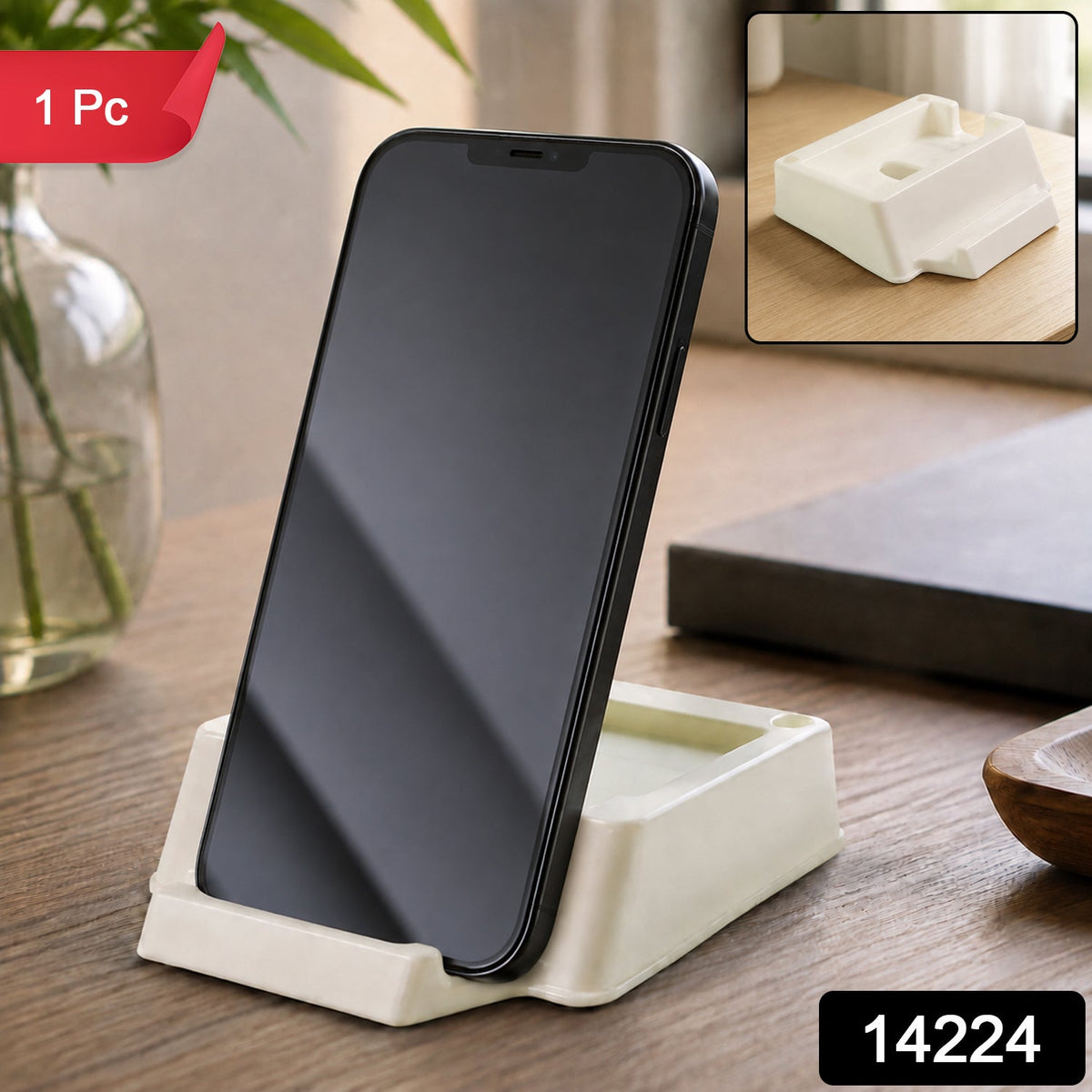 A black smartphone stands vertically in a cream plastic holder on a wooden table, with a red "1 Pc" tag and product number.