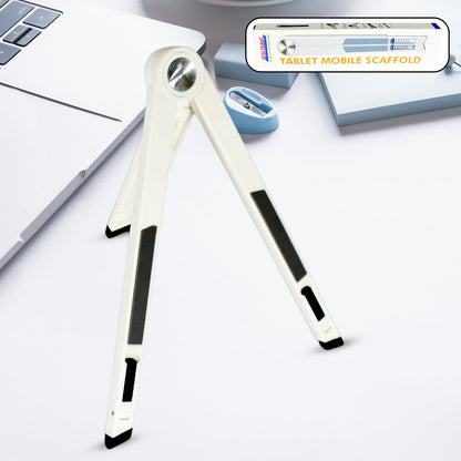 A white foldable stand with black grip pads is open on a white desk next to a laptop and pencil sharpener.