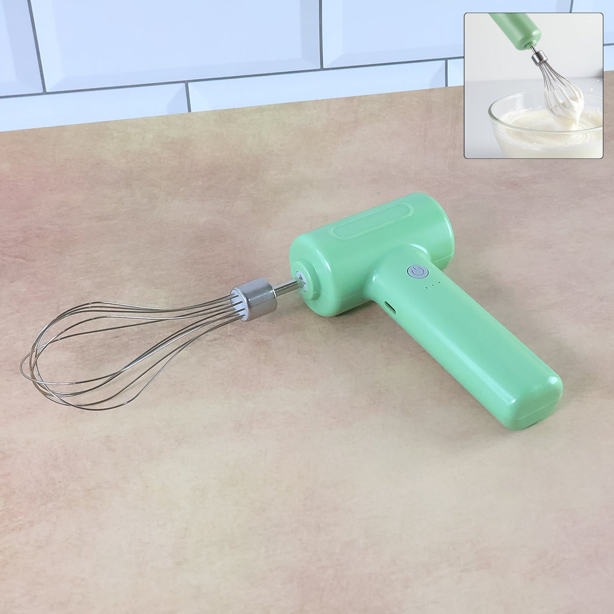 Light green cordless electric whisk on a brown counter; an inset shows the whisk mixing in a bowl.