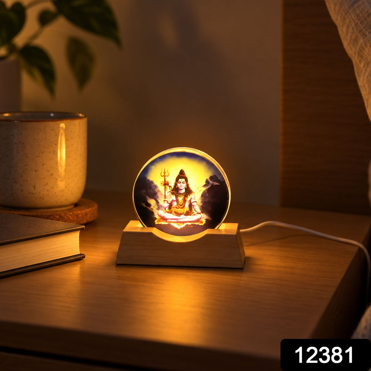 Glowing Shiva lamp on a wooden nightstand beside a book and ceramic mug, casting a warm light.