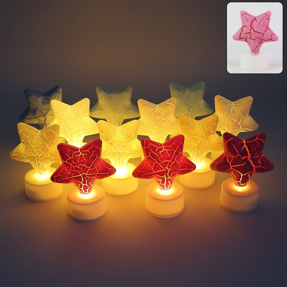 A group of twelve star-shaped LED tealight candles in red, yellow, and blue, glowing warmly in a dim setting.