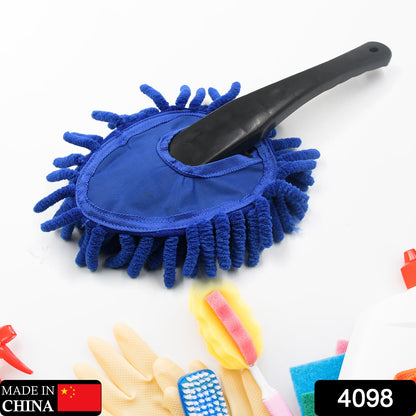 Blue microfiber duster with a black handle surrounded by cleaning supplies including gloves and sponges.