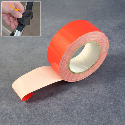 A roll of red tape with a small inset showing a hand applying black tape to a metal bar