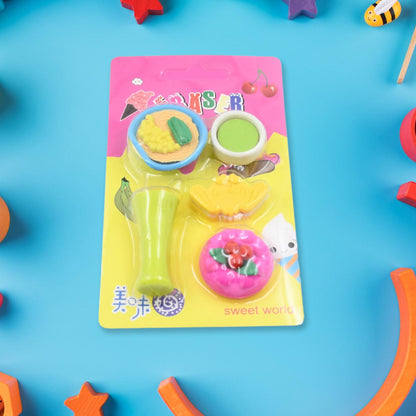 A blister pack containing five food-shaped erasers, including a green drink, a bowl of ramen, a pink cake, and a yellow