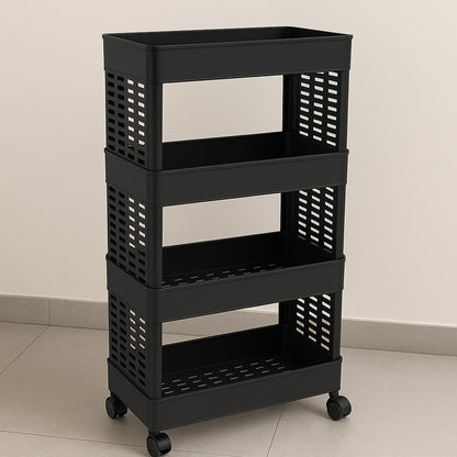 A black four-tier plastic utility trolley on wheels, empty, against a light-colored wall and floor.