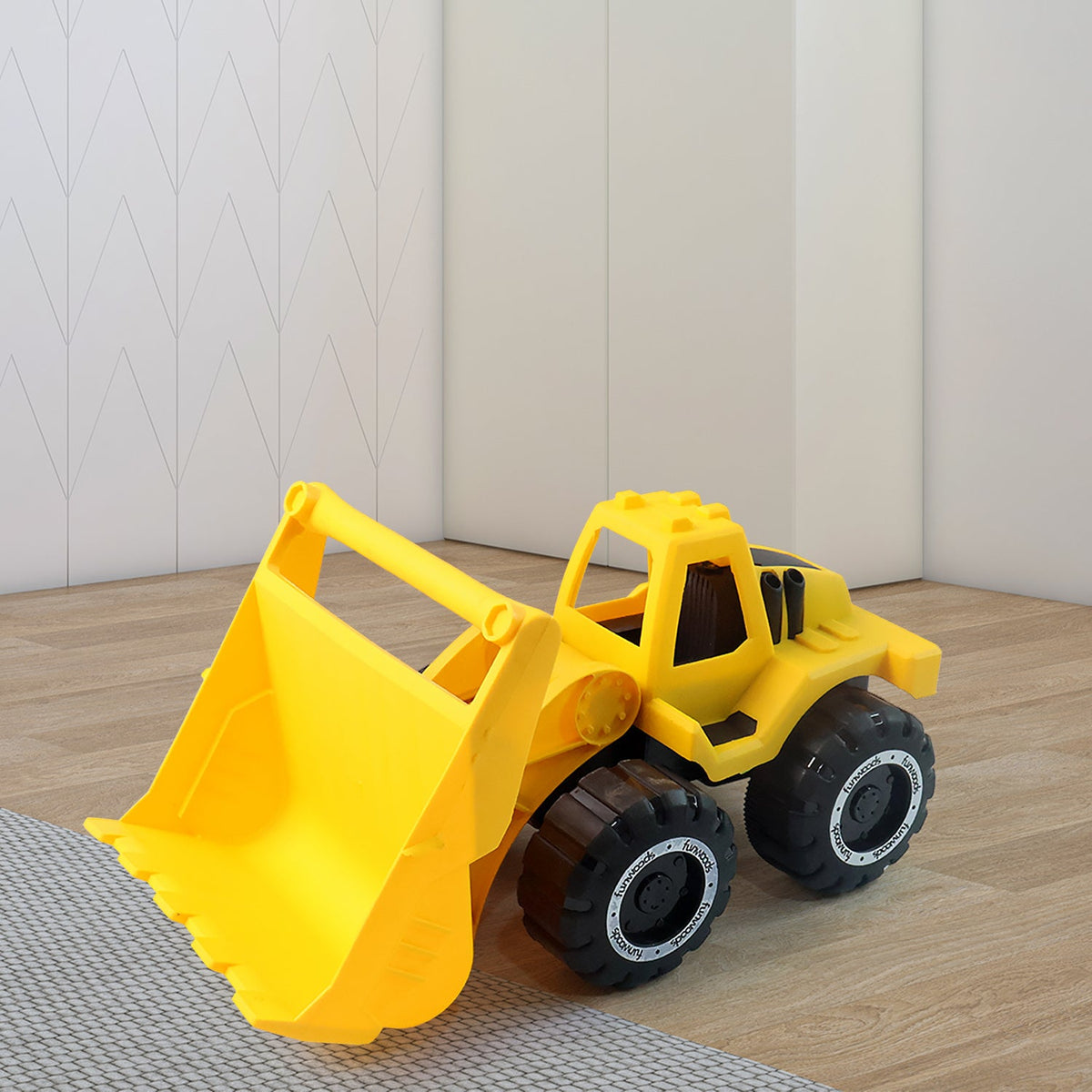 Detail of the movable bucket on yellow plastic toy front-end loader