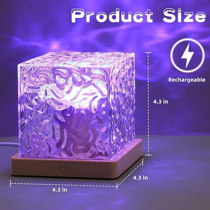 A crystal cube lamp projecting purple ripples, with dimensions 4.3 inches by 4.3 inches and a rechargeable icon.