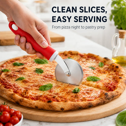 A hand uses a red-handled pizza cutter to make clean slices on a round pizza with basil leaves.