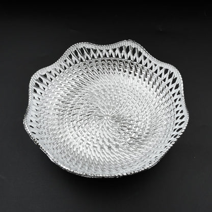 A silver plastic scalloped serving bowl with a textured bottom is centered on a black background.