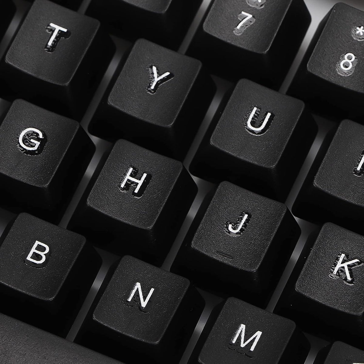 A close-up view of several black keyboard keys with white letters and numbers.