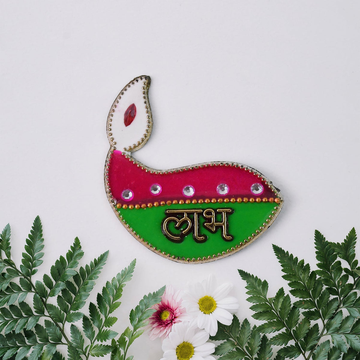 A single green and pink diya-shaped sticker with 'Labh' in gold, surrounded by green leaves and small white and pink flowers.