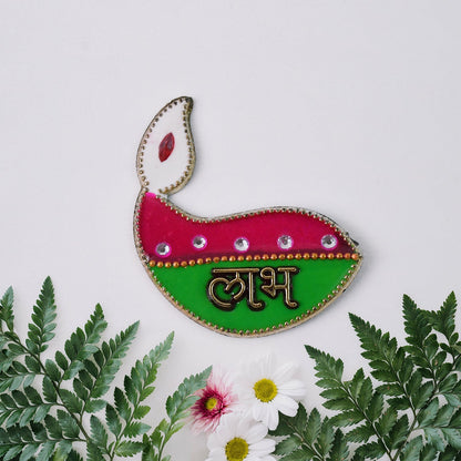 A single green and pink diya-shaped sticker with 'Labh' in gold, surrounded by green leaves and small white and pink flowers.