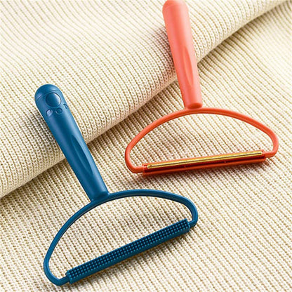 A blue fabric brush lint remover and an orange metal shaver lint remover resting on a light beige knitted fabric.