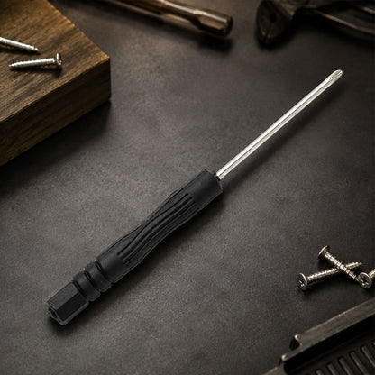 A black and silver mini screwdriver rests on a dark surface surrounded by various screws and tools.