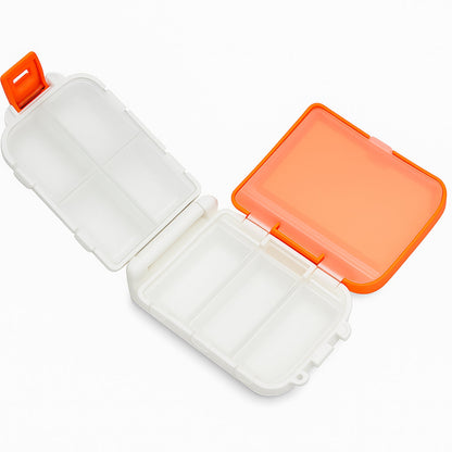 Top-down view of orange portable pill organizer with transparent lids