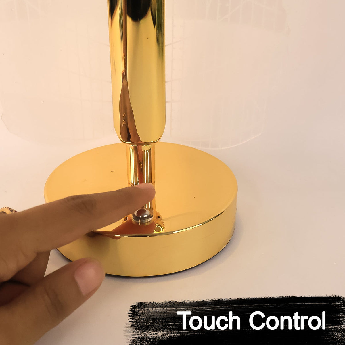 A close-up of a hand touching the gold base of the lamp, labeled "Touch Control".