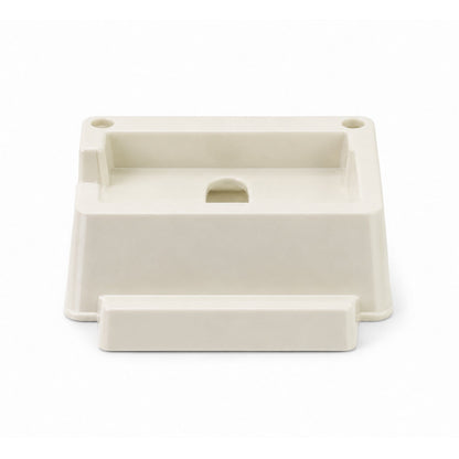 A cream plastic phone stand with two small holes and a larger central opening is shown from the front.