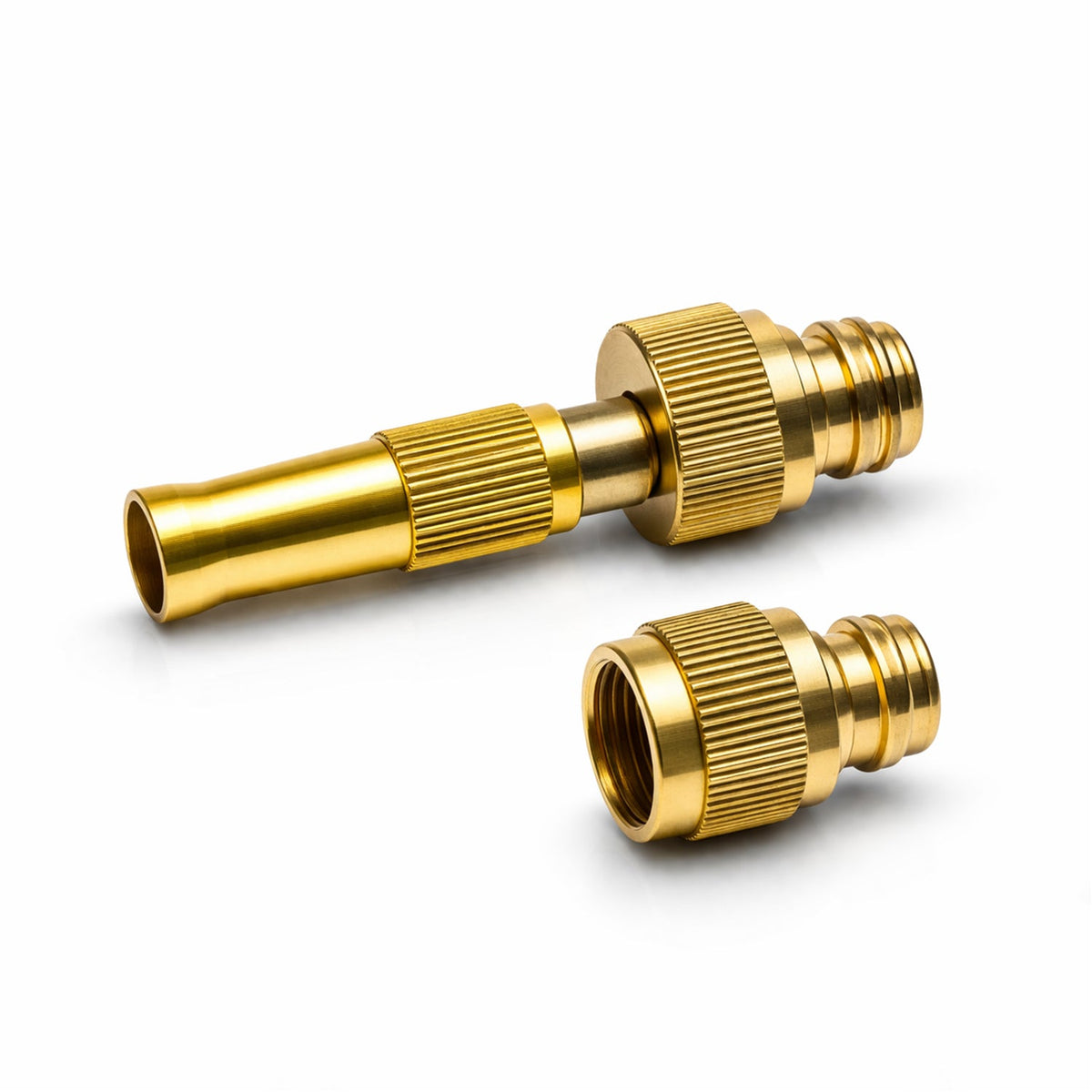 A brass hose nozzle and a separate brass connector with ridged textures rest on a clean white surface.