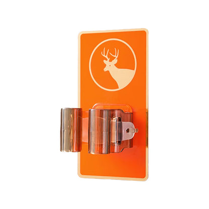 A close-up of the orange deer-themed wall-mounted holder with a transparent brown gripper, isolated on a white background.