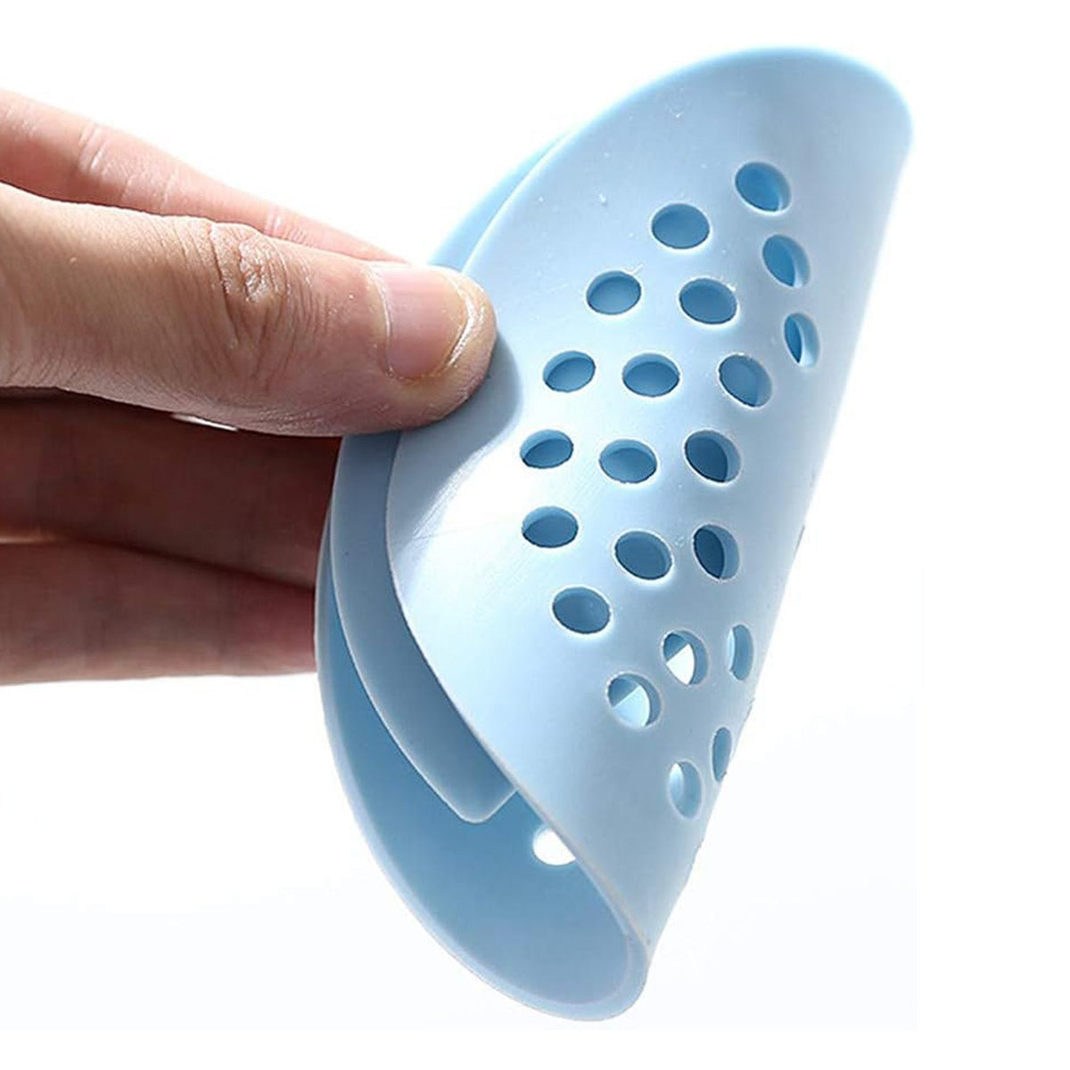 A hand holds a light blue silicone drain strainer, bent to show its flexibility and perforated design.