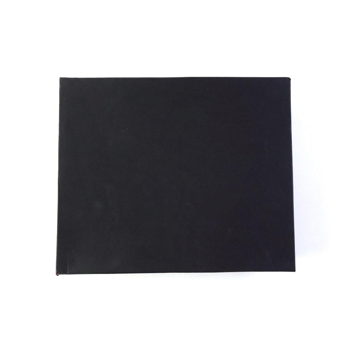 Top-down view of a plain black rectangular gift box on a white background.