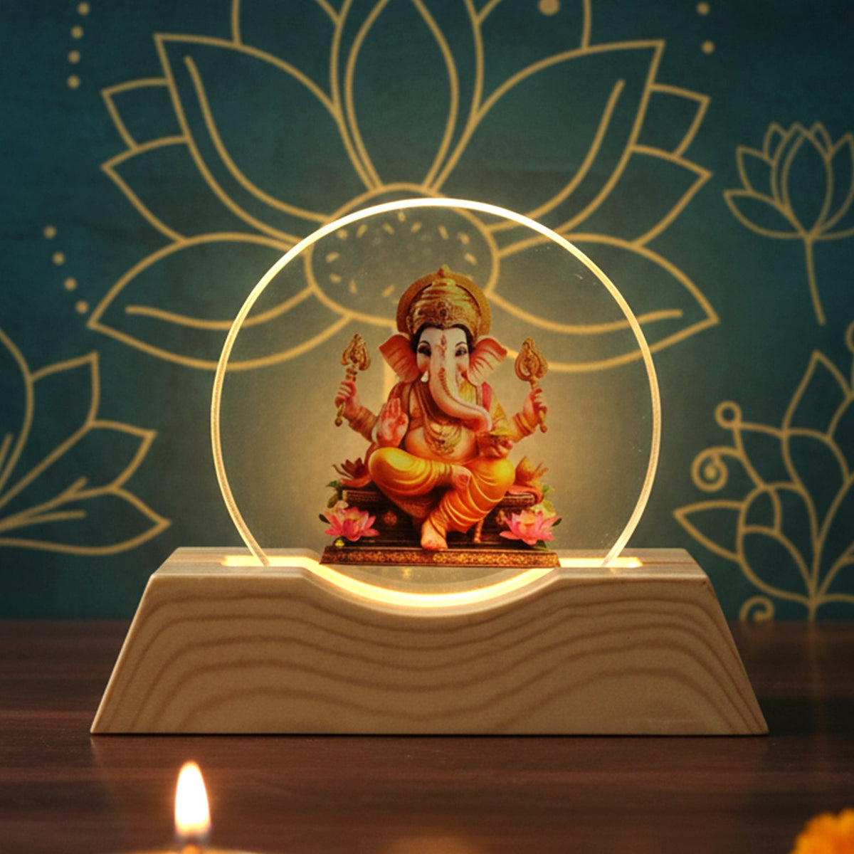 Lord Ganesha LED lamp with a golden glow against a dark blue background with lotus patterns.