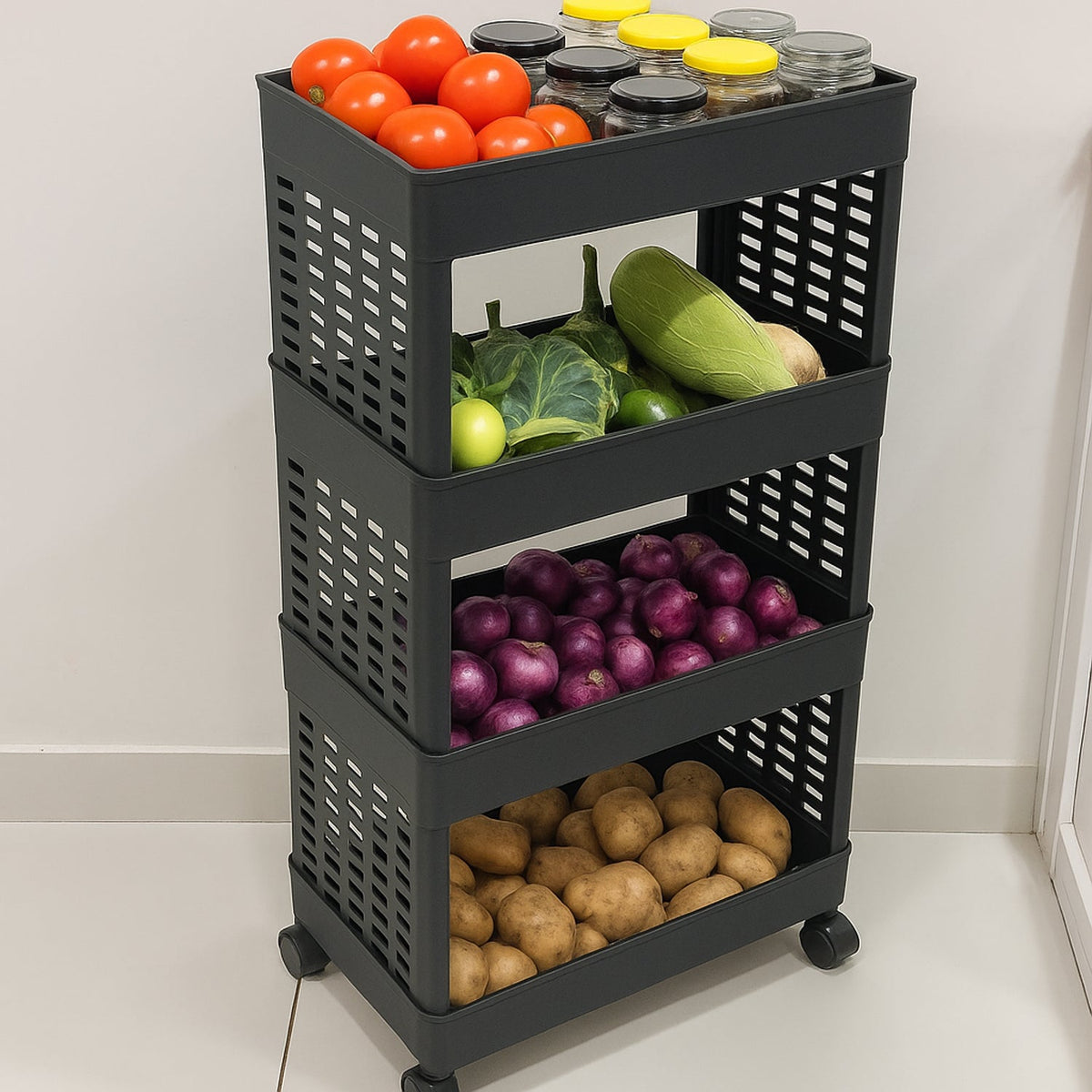 A black four-tier plastic utility trolley on wheels, filled with tomatoes, various vegetables, red onions, and potatoes.