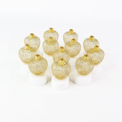 Twelve unlit gold mesh tealight covers on white bases, arranged in a grid on a plain white background.