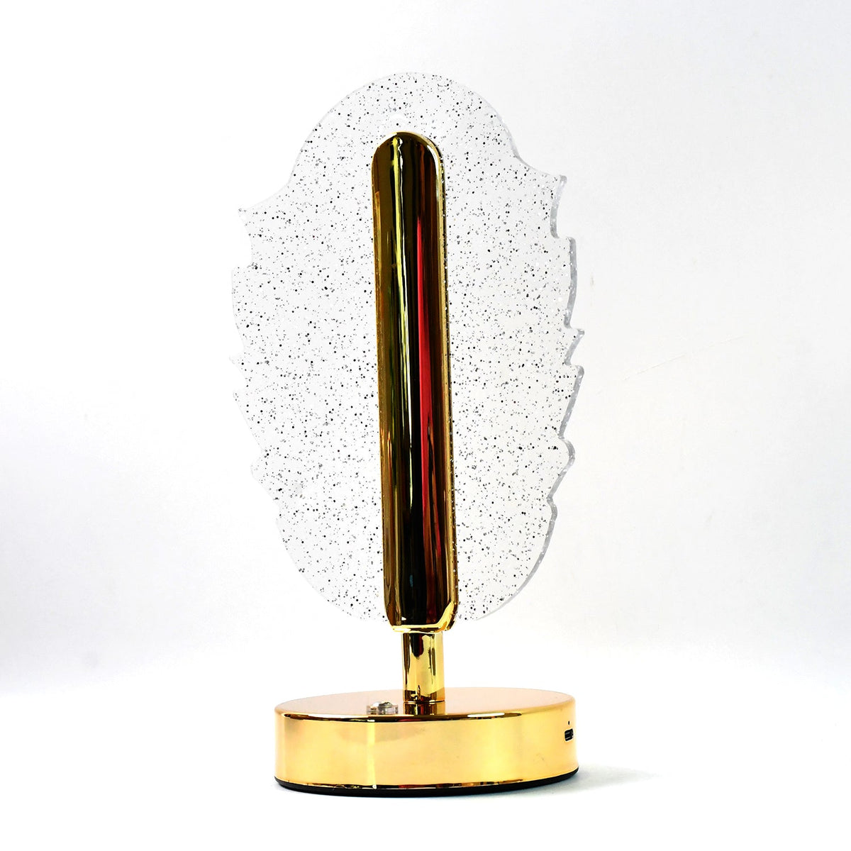 A feather-shaped crystal table lamp with a gold base on a white background, viewed from a slight angle.