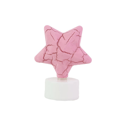 A single pink star-shaped LED tealight candle with a cracked texture, standing on a white base.