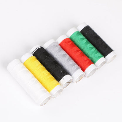 Eight spools of colorful thread, including white, yellow, black, grey, red, green, black, and blue, arranged diagonally.