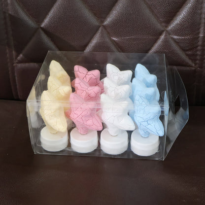 Four star-shaped LED tealight candles in yellow, pink, white, and blue, packaged in a clear plastic box.