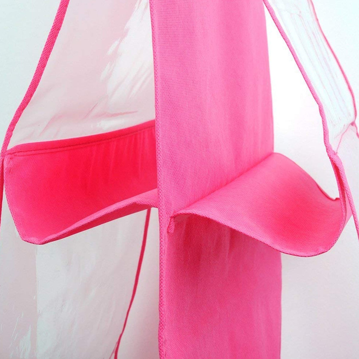 Close-up of the pink fabric and clear plastic pockets of the hanging purse organizer.