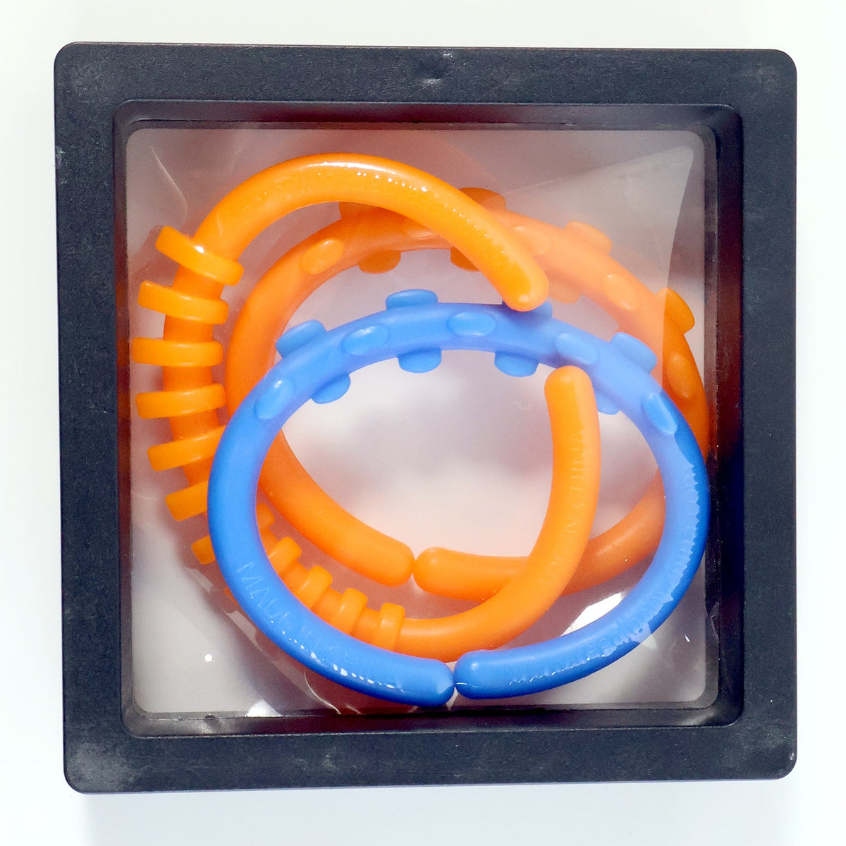 Three orange and blue learning links are packaged in a clear plastic box with a black frame.