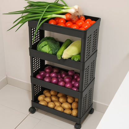 A black four-tier plastic utility trolley on wheels, filled with spring onions, tomatoes, cabbage, cucumber, red onions, and