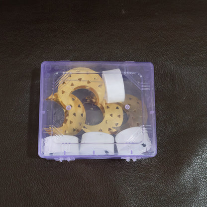 A clear plastic box containing four disassembled crescent moon LED tea lights, with gold moon shapes and white bases.