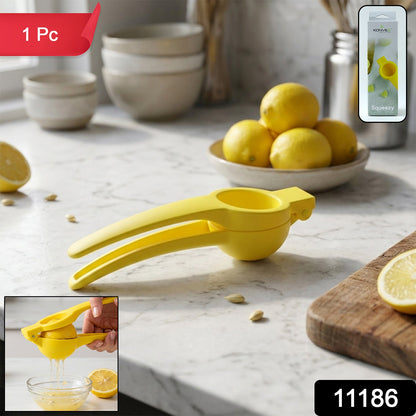 Hands squeezing a lemon in the yellow juicer, dripping juice into a clear bowl next to a cut lemon.