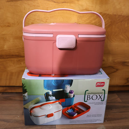 Closed pink storage box with a wavy handle sitting on top of its product packaging box, against a wooden background.