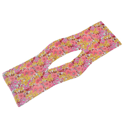 Pink and yellow floral hair bun maker with an elongated oval cutout in the center.