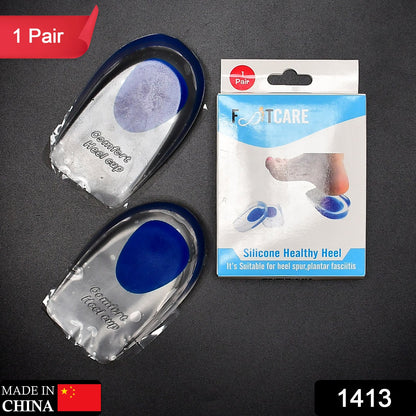 Two clear gel heel cups with blue centers are next to a white and blue box labeled "FOOTCARE Silicone Healthy Heel."