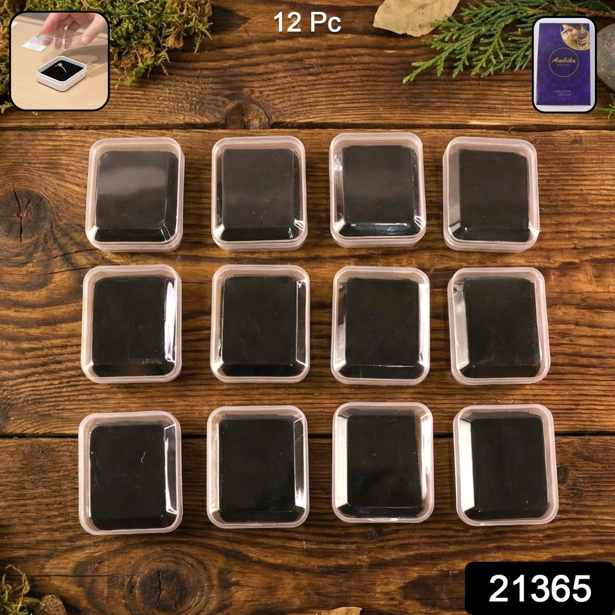 Twelve clear-lidded white jewellery boxes with black inserts arranged on a rustic wooden surface with green foliage.