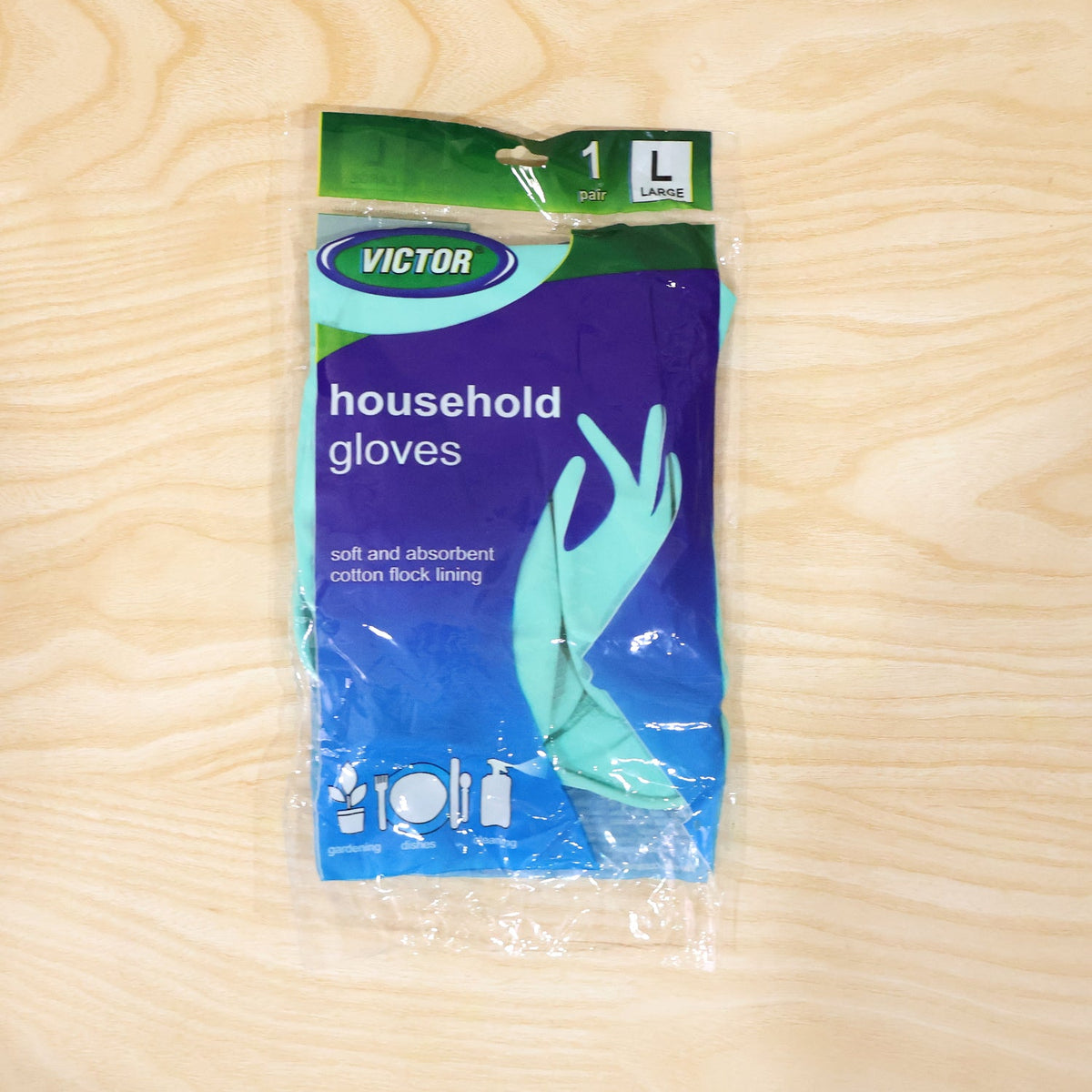 A single pair of large teal household gloves in clear plastic packaging with blue and green branding is centered on a light