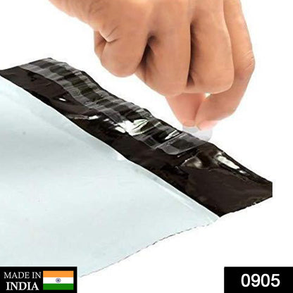 A hand peeling the protective strip off the black adhesive seal of a white poly mailer bag.