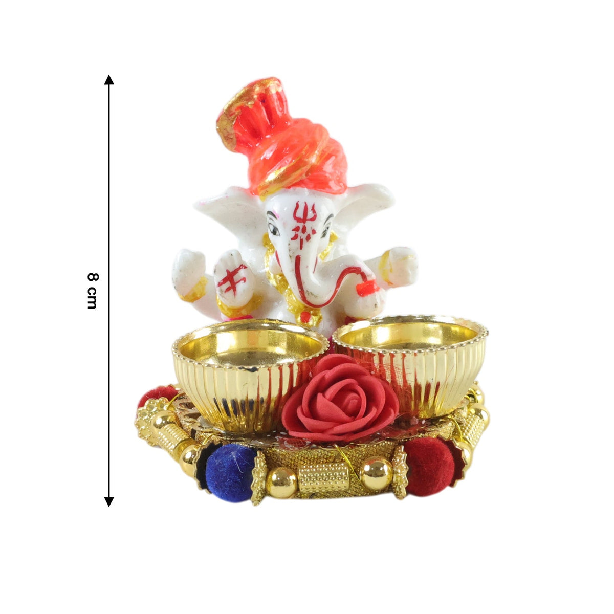 A white Ganesha idol with an orange turban on a gold base with two empty gold bowls and a red rose, with an 8 cm height
