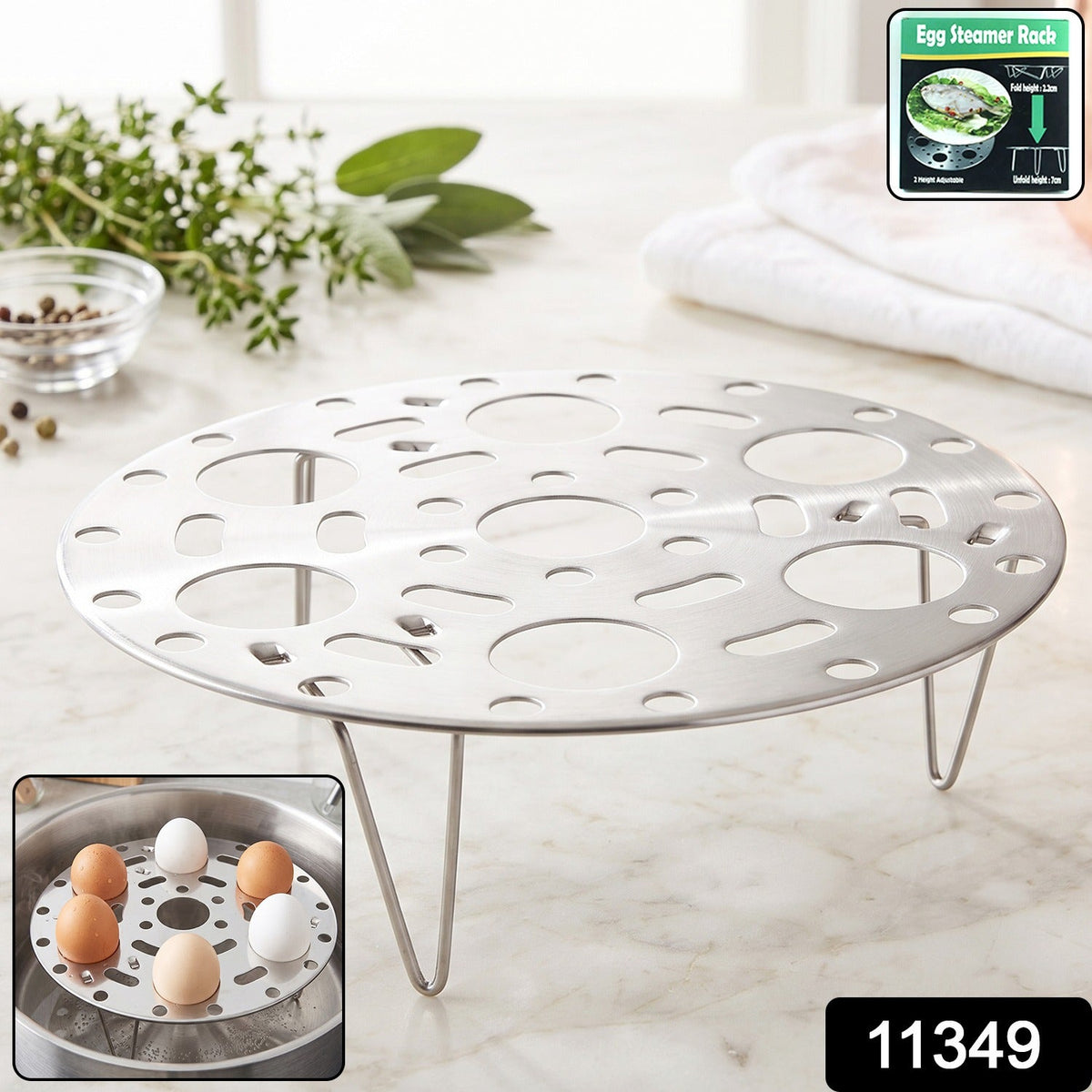 A shiny metal egg steamer rack with three legs sits on a white marble counter, with an inset of the rack in use.