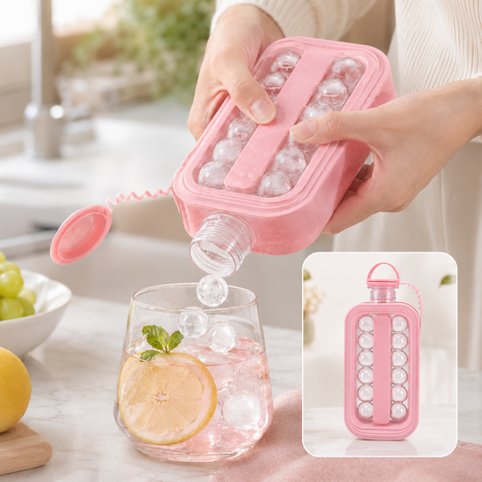A person dispenses spherical ice cubes from a pink bottle into a glass of pink drink with lemon and mint. Inset shows the