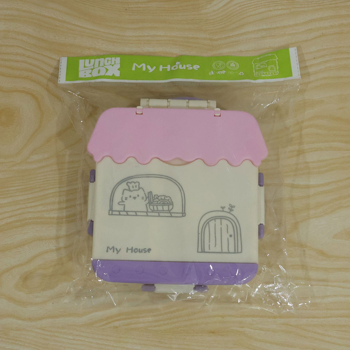 Child holding the house shape kids lunch box, ready for school