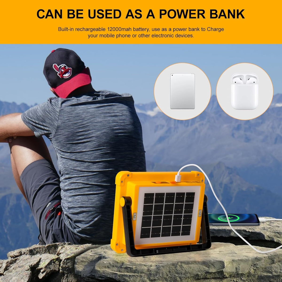 A person sitting on rocks with a yellow solar LED flood light charging a phone, highlighting its power bank function.